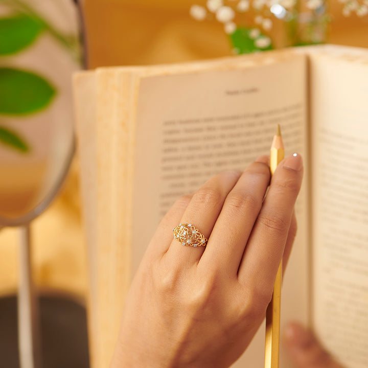 Floral nose ring with decorative charm.